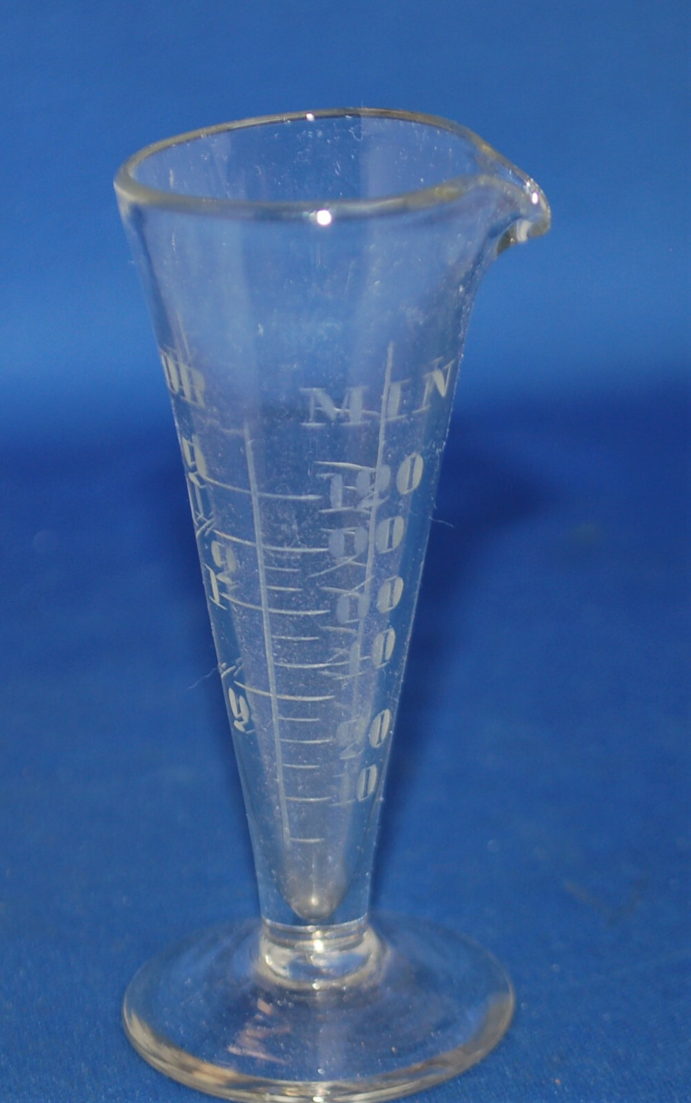 An antique apothecary measuring glass vessel, clear, engraved, fluted