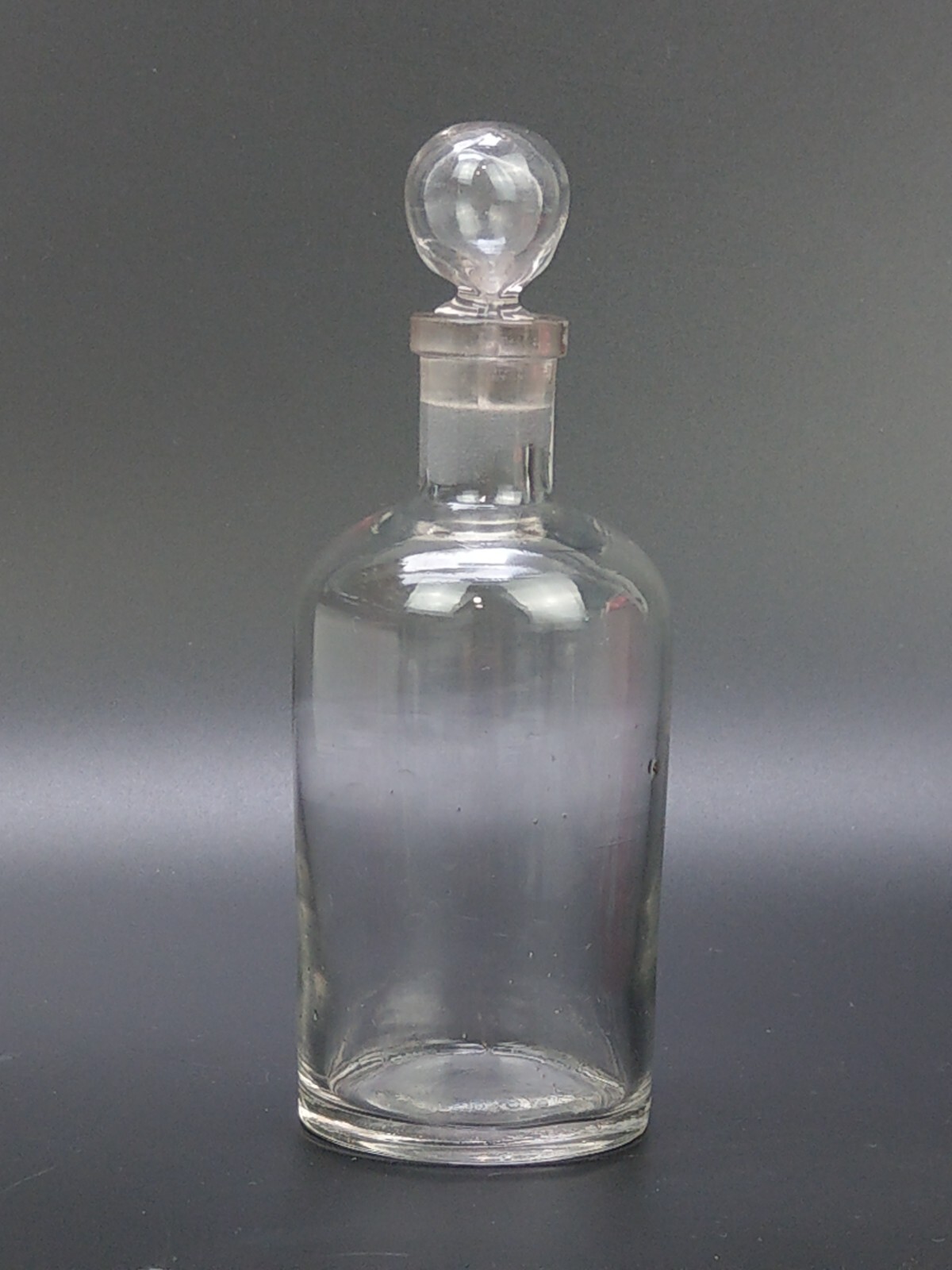 Antique clear medicine bottle with stopper medium size