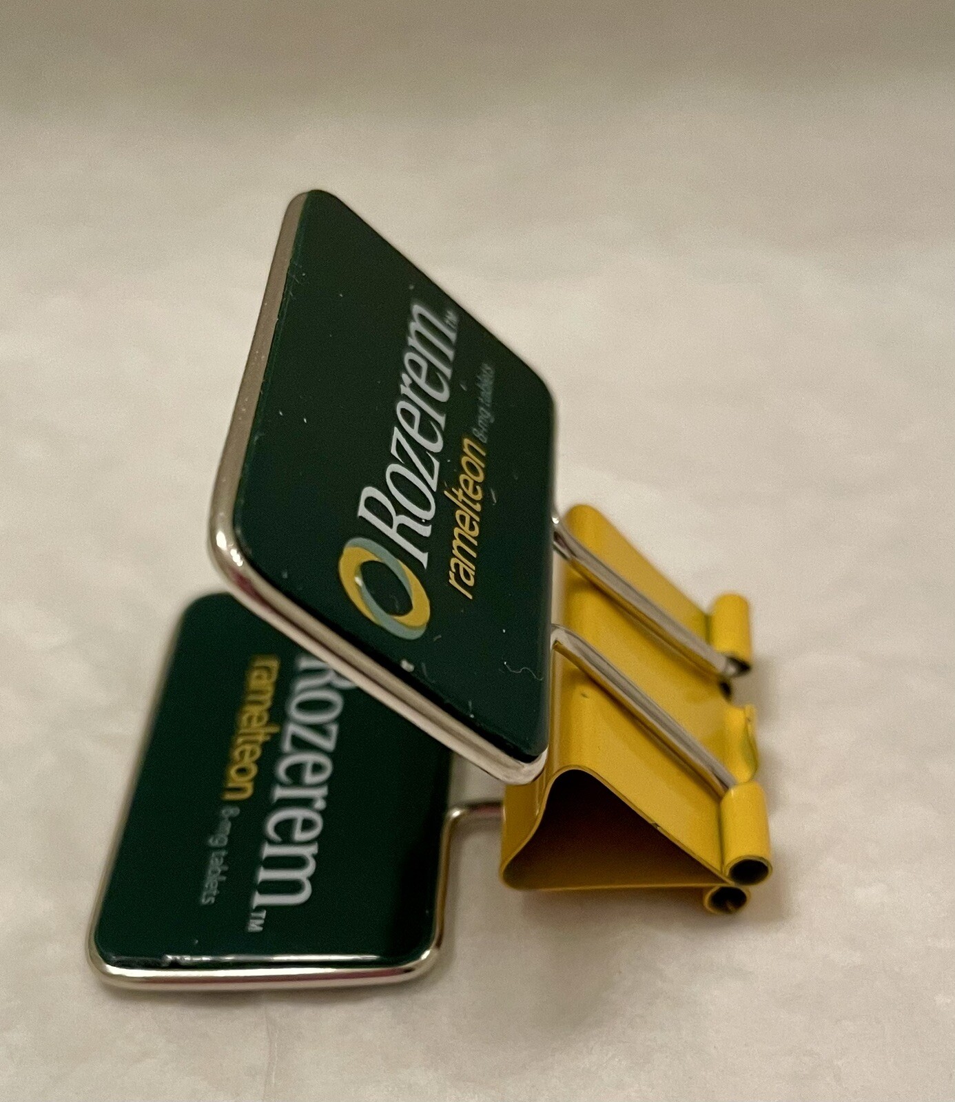 VINTAGE ROZEREM GREEN/YELLOW BINDER CLIP PHARMACEUTICAL DRUG REP LOGO NEW