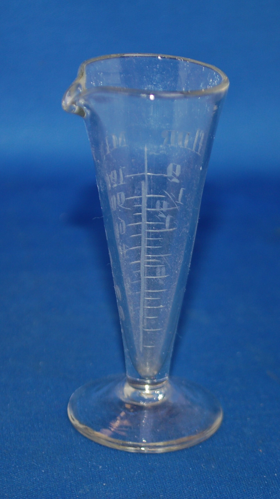 An antique apothecary measuring glass vessel, clear, engraved, fluted