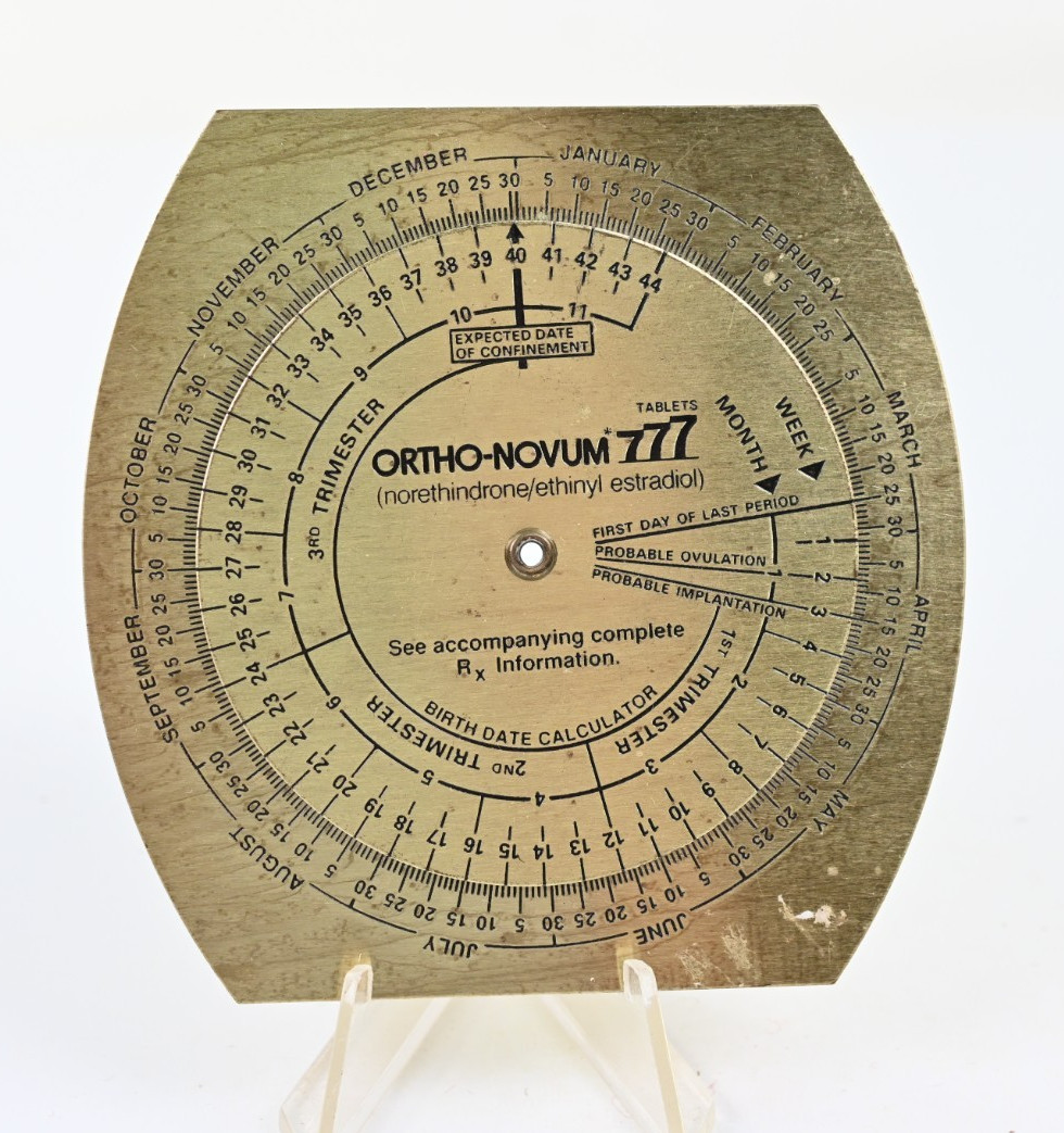 1987 Brass Ortho Novum 777 Birth Date Calculator Wheel OB GYN Medical Drug Promo