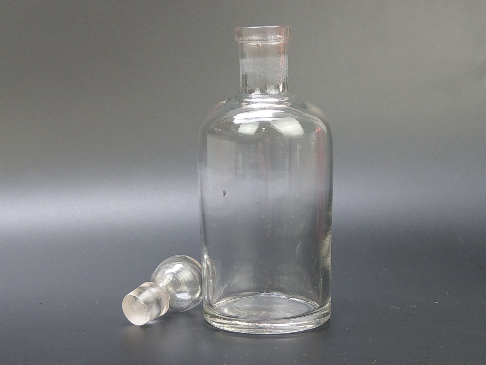 Antique clear medicine bottle with stopper medium size