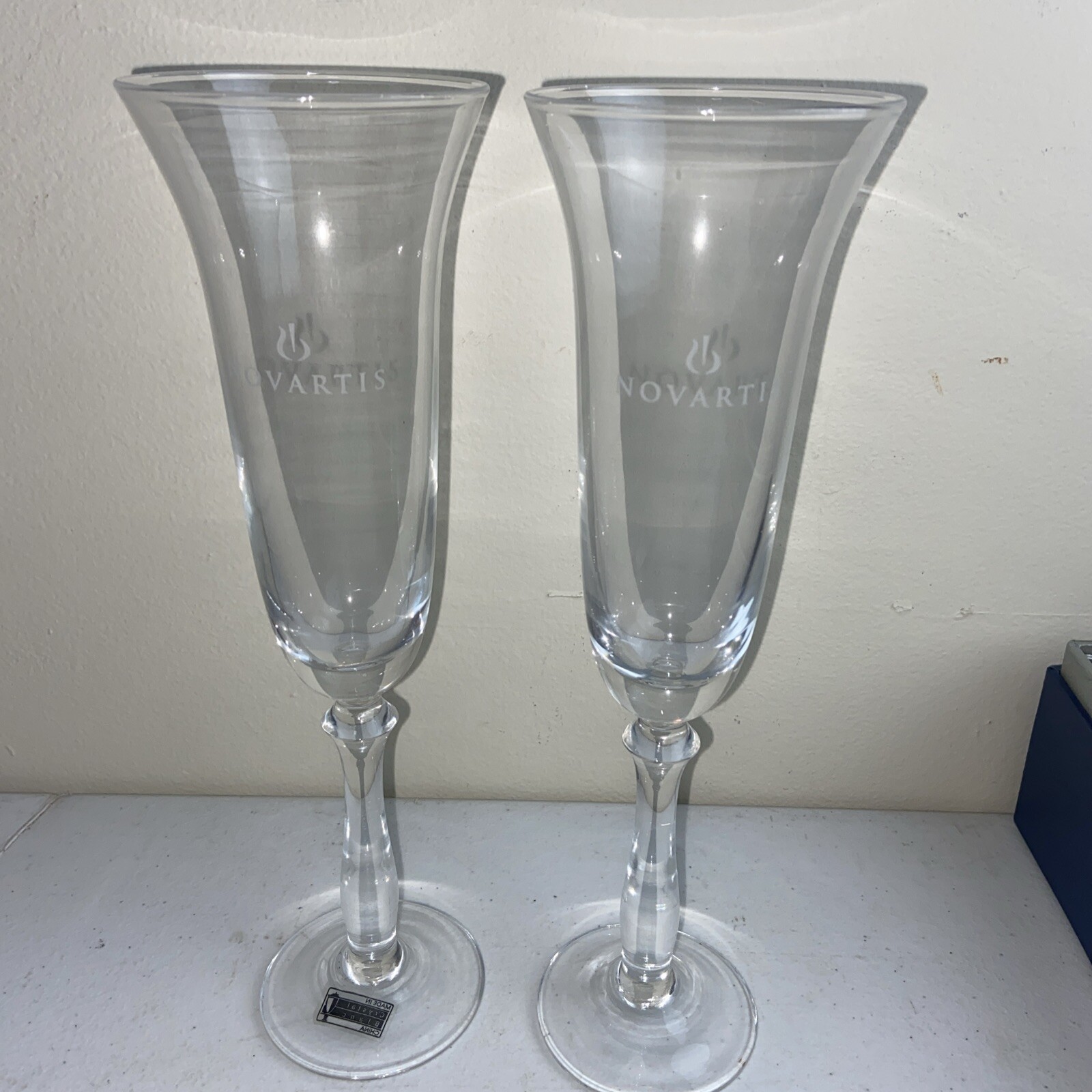 NOVARTIS Champagne Glasses Set Of 2 Clear Crystal 10” Tall Pharmacy Medical NOS
