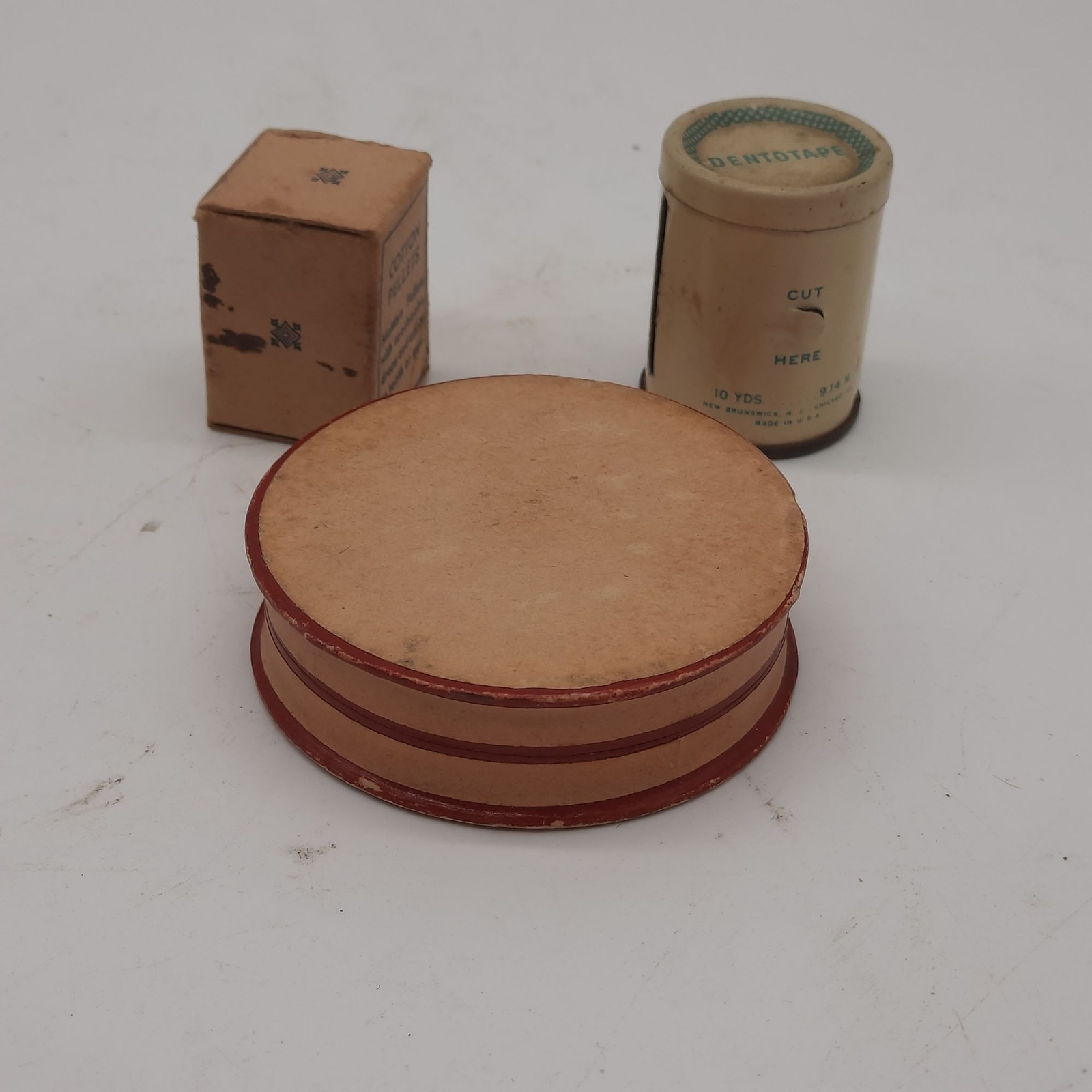 Vintage medicine cabinet packaging, cotton pellets, floss, lozenges, paper, meta